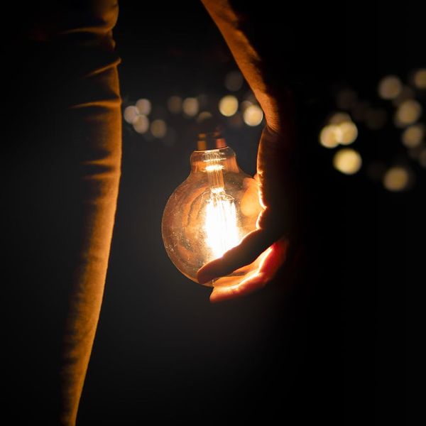 Silhouette of a person meditating against a warm, glowing background.